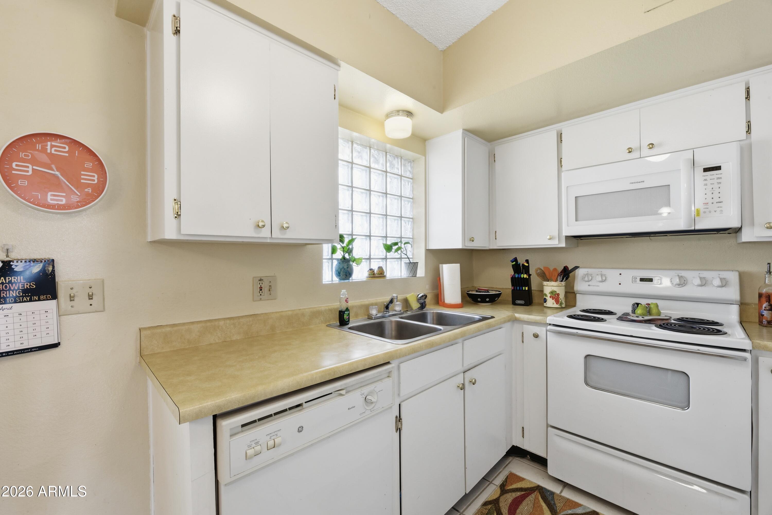 641 South Power Road, Unit 366 Mesa, AZ 85206 - Photo 18 of 22 a kitchen with stainless steel appliances granite countertop a sink and a stove