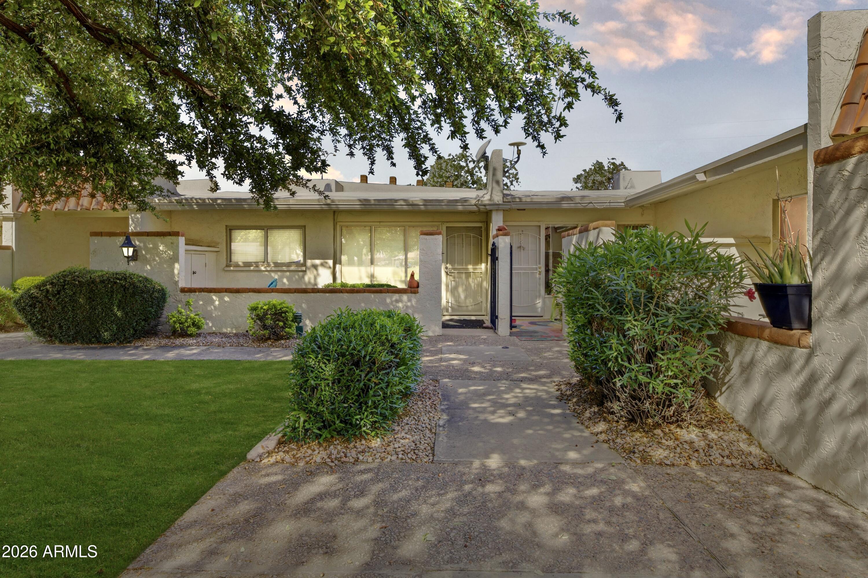 641 South Power Road, Unit 366 Mesa, AZ 85206 - Photo 2 of 22 a front view of a house with a yard and green space
