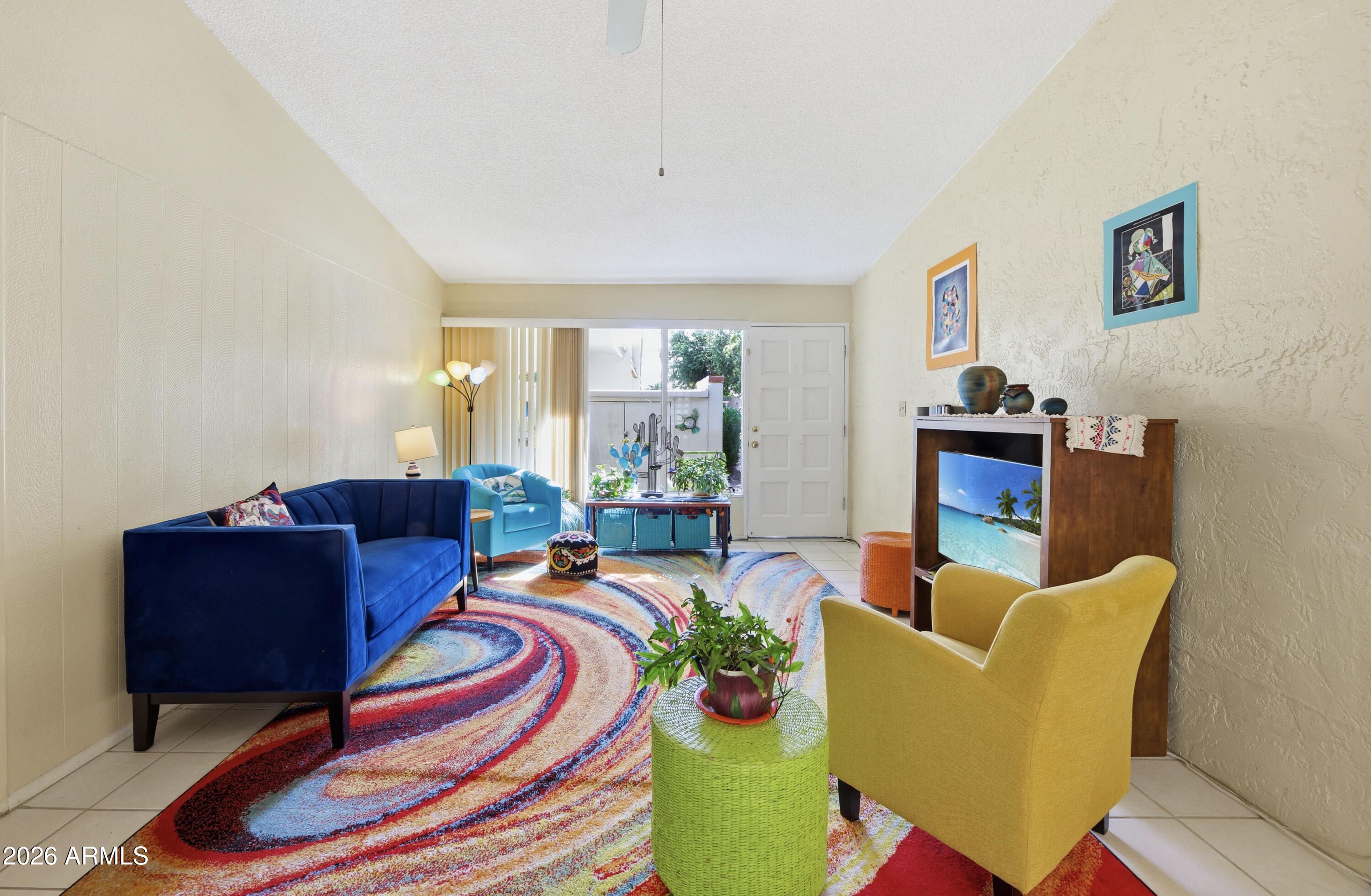 641 South Power Road, Unit 366 Mesa, AZ 85206 - Photo 6 of 22 a living room with furniture and a floor to ceiling window