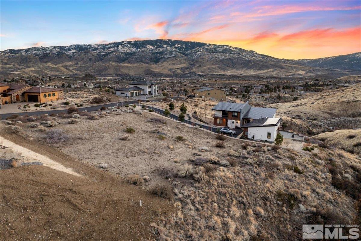 8673 Eagle Chase Trail, Unit 444 Reno, NV 89523 - Photo 12 of 14 a view of a dry field with mountains in the background