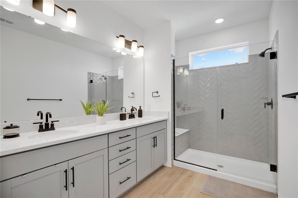 731 FIREROCK Lane DeBary, FL 32713 - Photo 13 of 39 a bathroom with a double vanity sink toilet mirror and shower