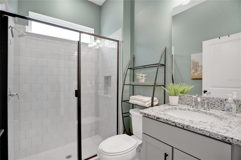 731 FIREROCK Lane DeBary, FL 32713 - Photo 18 of 39 a bathroom with a granite countertop sink toilet and shower