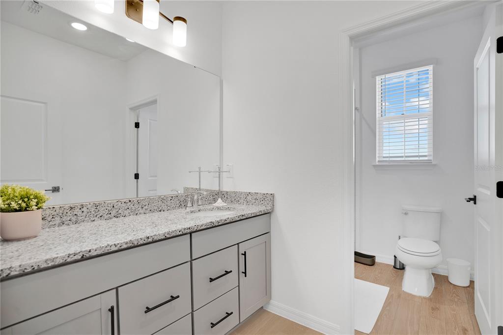731 FIREROCK Lane DeBary, FL 32713 - Photo 20 of 39 a bathroom with a granite countertop sink and a toilet