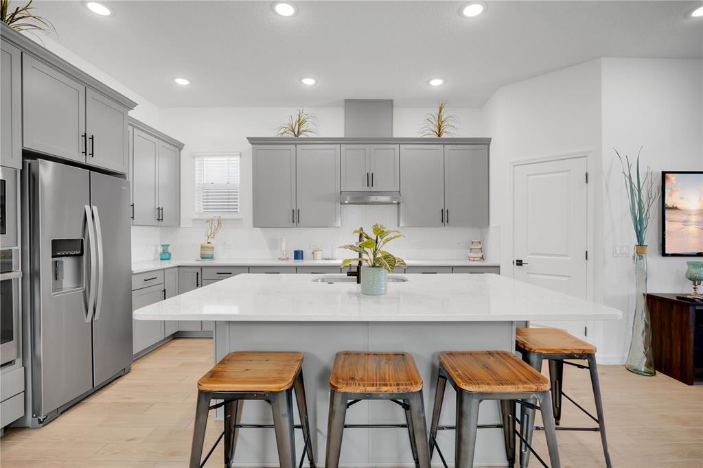 731 FIREROCK Lane DeBary, FL 32713 - Photo 5 of 39 a kitchen with white cabinets and stainless steel appliances