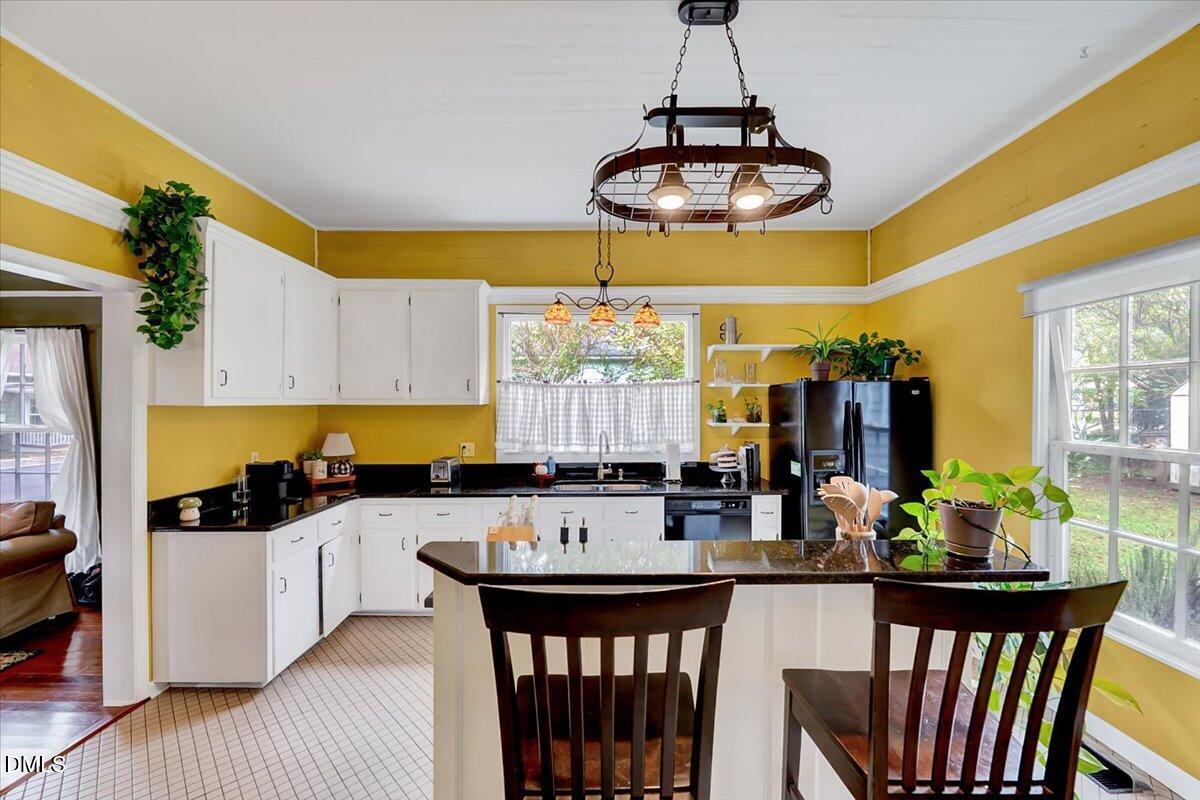 230 Brick Street Wake Forest, NC 27587 - Photo 15 of 38 a kitchen with stainless steel appliances a dining table chairs and white cabinets