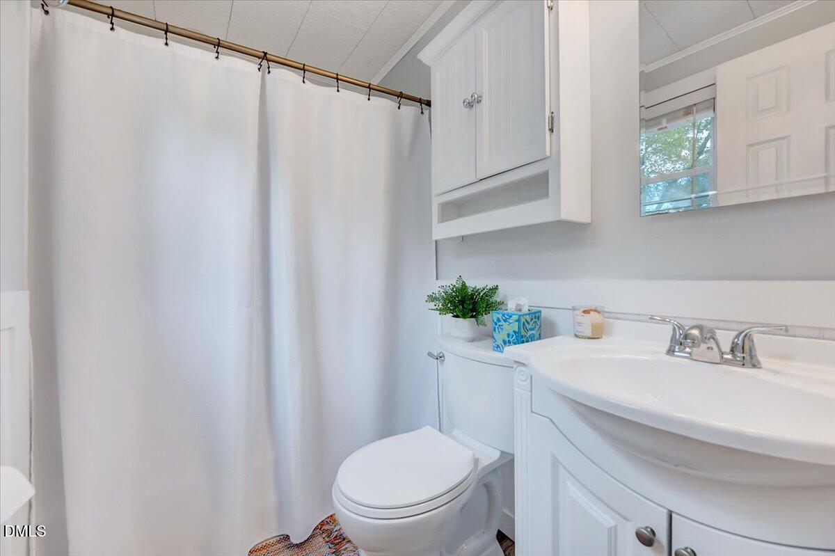 230 Brick Street Wake Forest, NC 27587 - Photo 18 of 38 a bathroom with a sink mirror and toilet