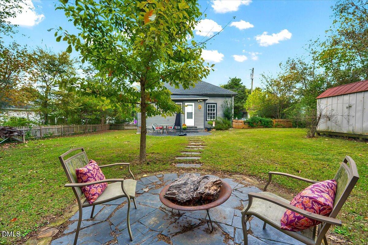 230 Brick Street Wake Forest, NC 27587 - Photo 23 of 38 a view of a chairs and table in the garden