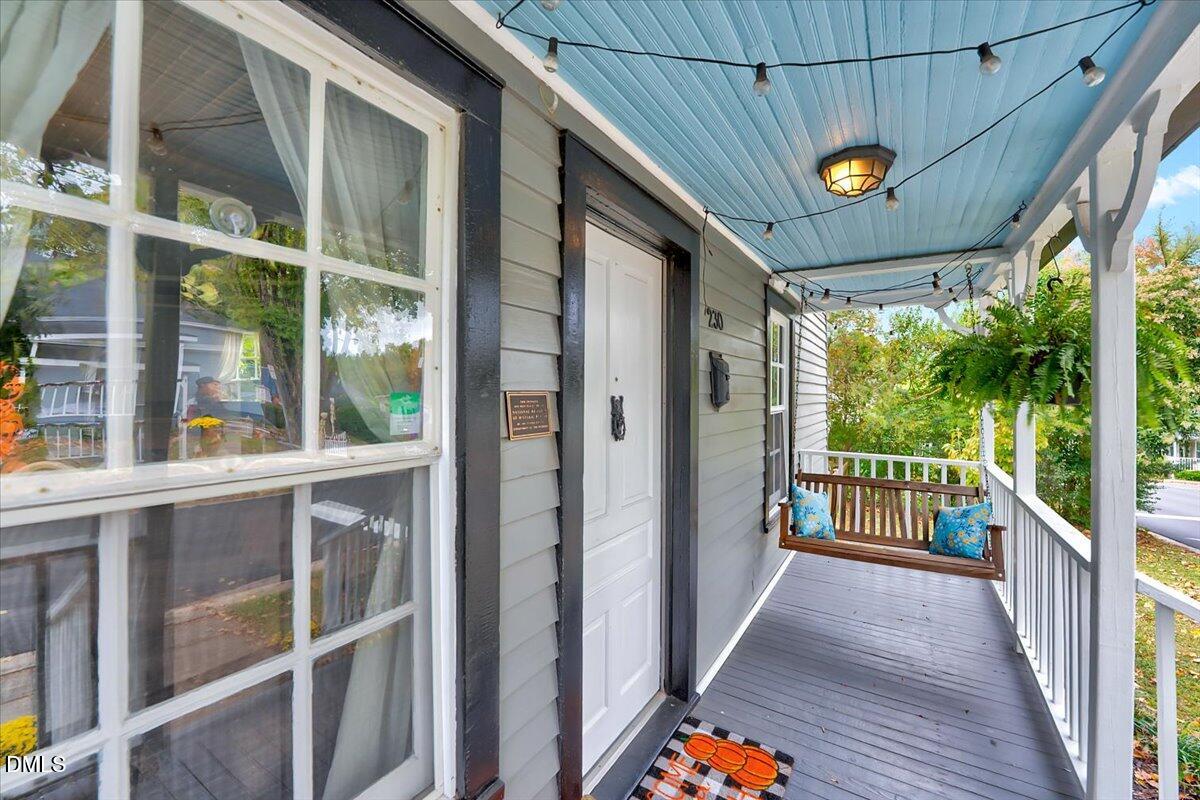 230 Brick Street Wake Forest, NC 27587 - Photo 31 of 38 a view of a porch with wooden floor and iron stairs