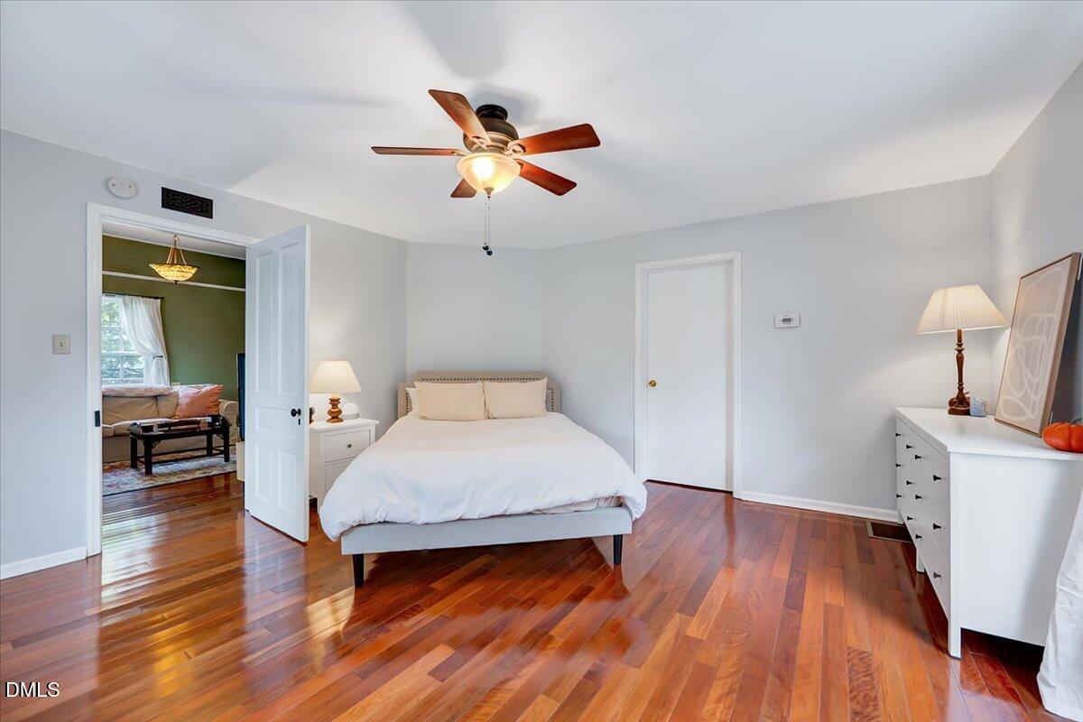 230 Brick Street Wake Forest, NC 27587 - Photo 8 of 38 a bedroom with a bed and wooden floor