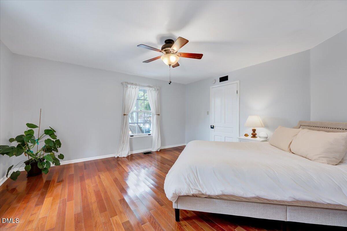230 Brick Street Wake Forest, NC 27587 - Photo 9 of 38 a bedroom with a bed and a chandelier