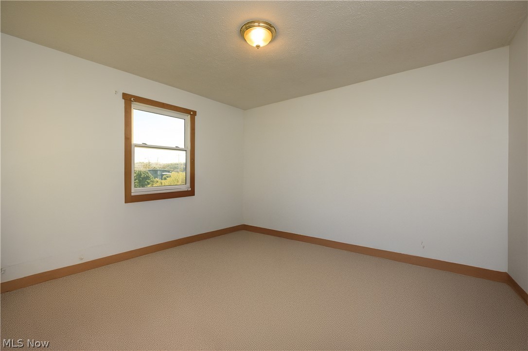 8200 Cutler Road Southwest Sherrodsville, OH 44675 - Photo 23 of 26 Carpeted spare room with baseboards