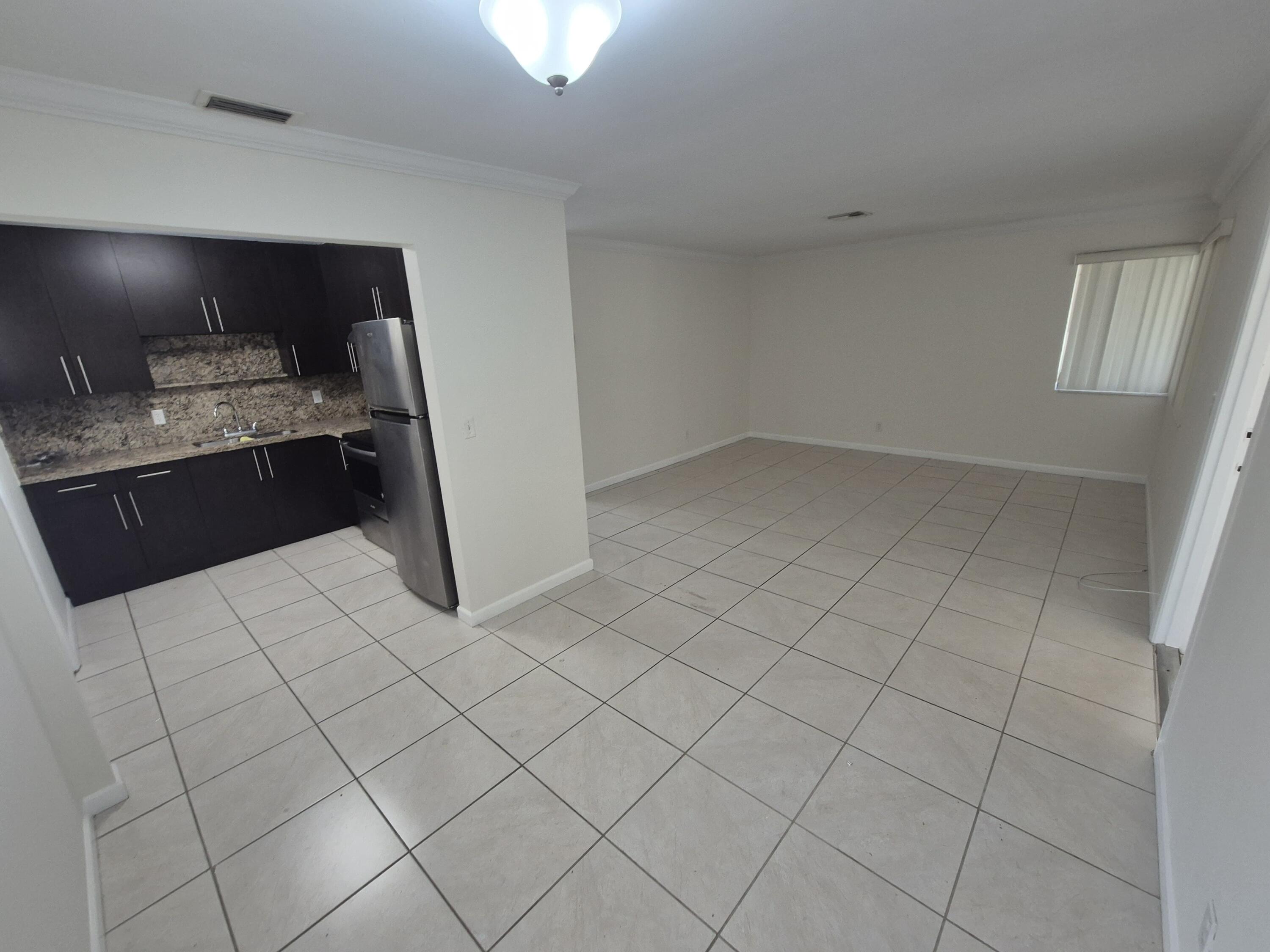 3518 Taylor Street, Unit 4 Hollywood, FL 33021 - Photo 7 of 13 a kitchen with a sink and cabinets