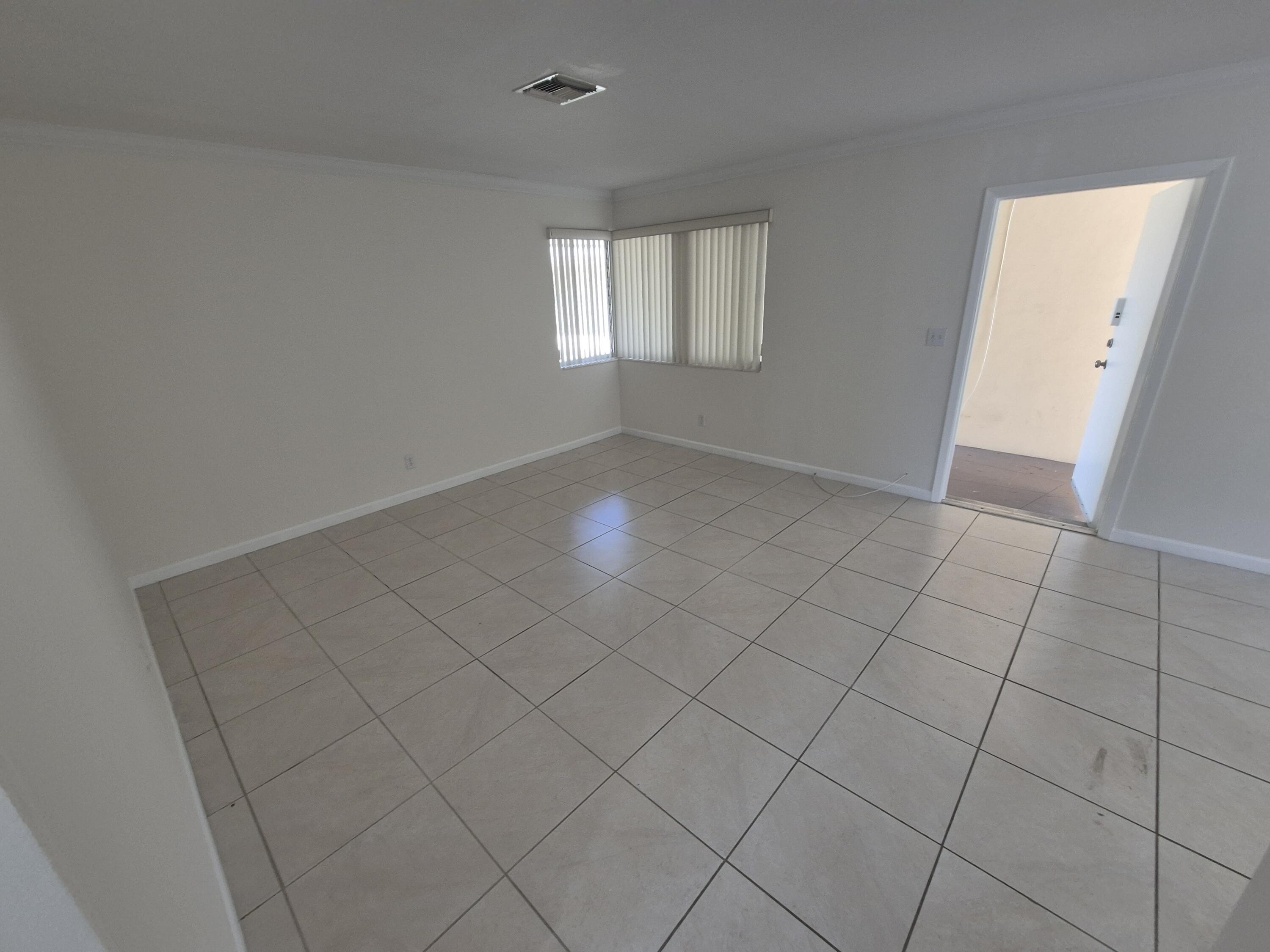 3518 Taylor Street, Unit 4 Hollywood, FL 33021 - Photo 8 of 13 an empty room with windows