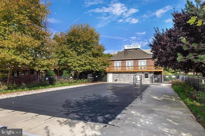 4040 Fairfax Center Hunt Trail Fairfax, VA 22030 - Photo 4 of 7 a front view of a house with a yard and trees