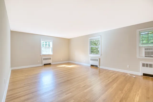 an empty room with windows and closet