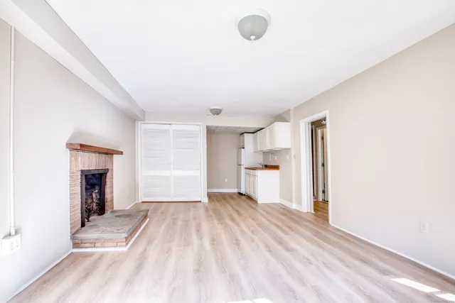 a view of a room with a fireplace and cabinet