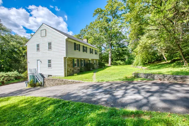 a view of a house with a yard and garage