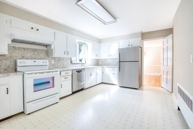 a kitchen with a white cabinets and white appliances