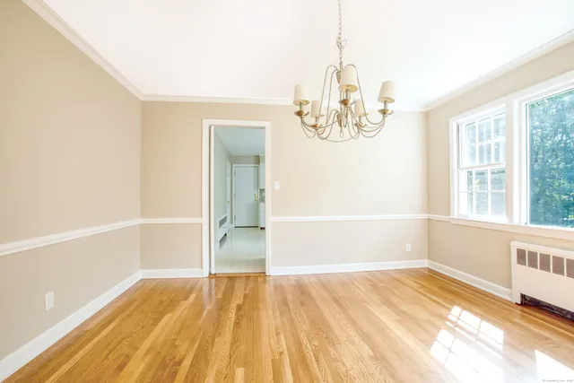 a view of a room with wooden floor and white walls