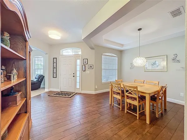 a view of a dining room with furniture and wooden floor