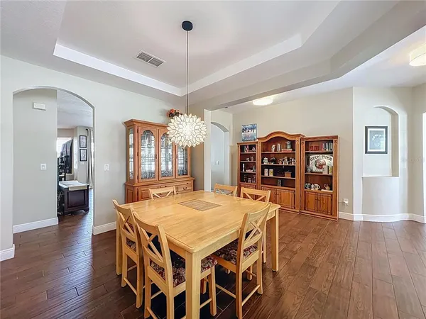 a view of a dining room with furniture and wooden floor