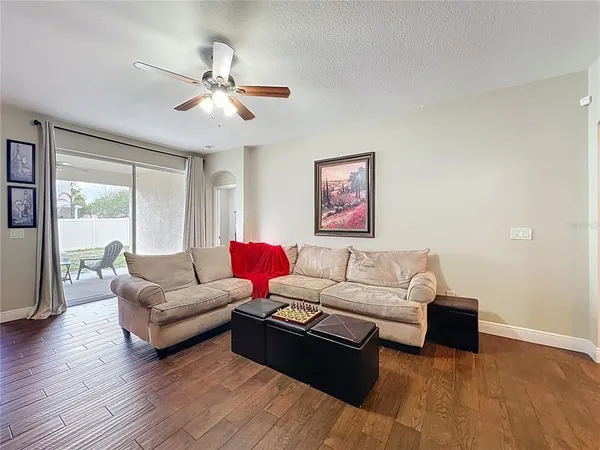 a living room with furniture and wooden floor