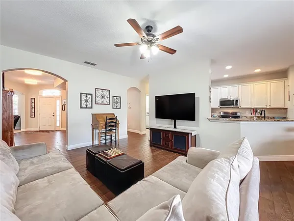 a kitchen with stainless steel appliances granite countertop a refrigerator a stove top oven and a sink