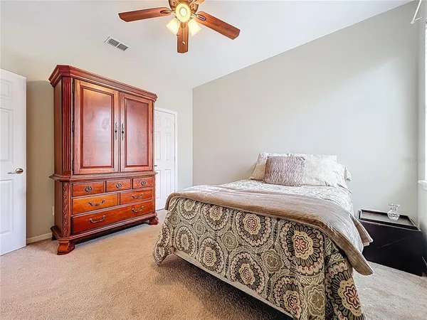 a bedroom with a bed and a book shelf