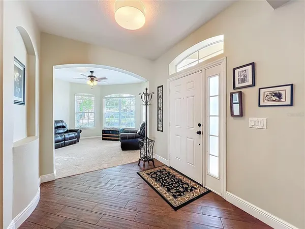 a view of a livingroom with wooden floor and furniture