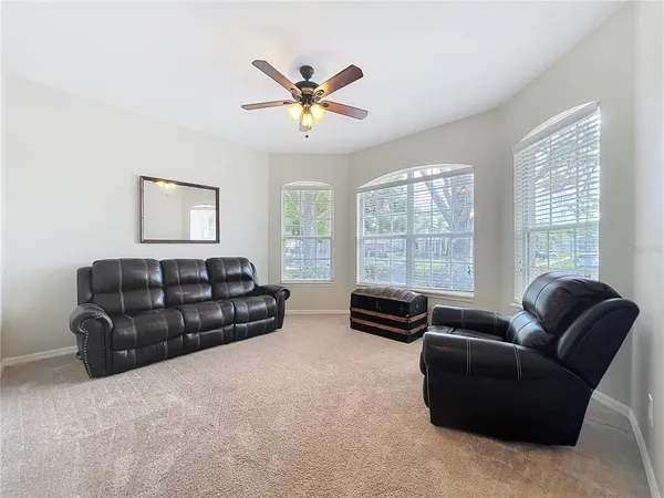 a living room with furniture window and a flat screen tv