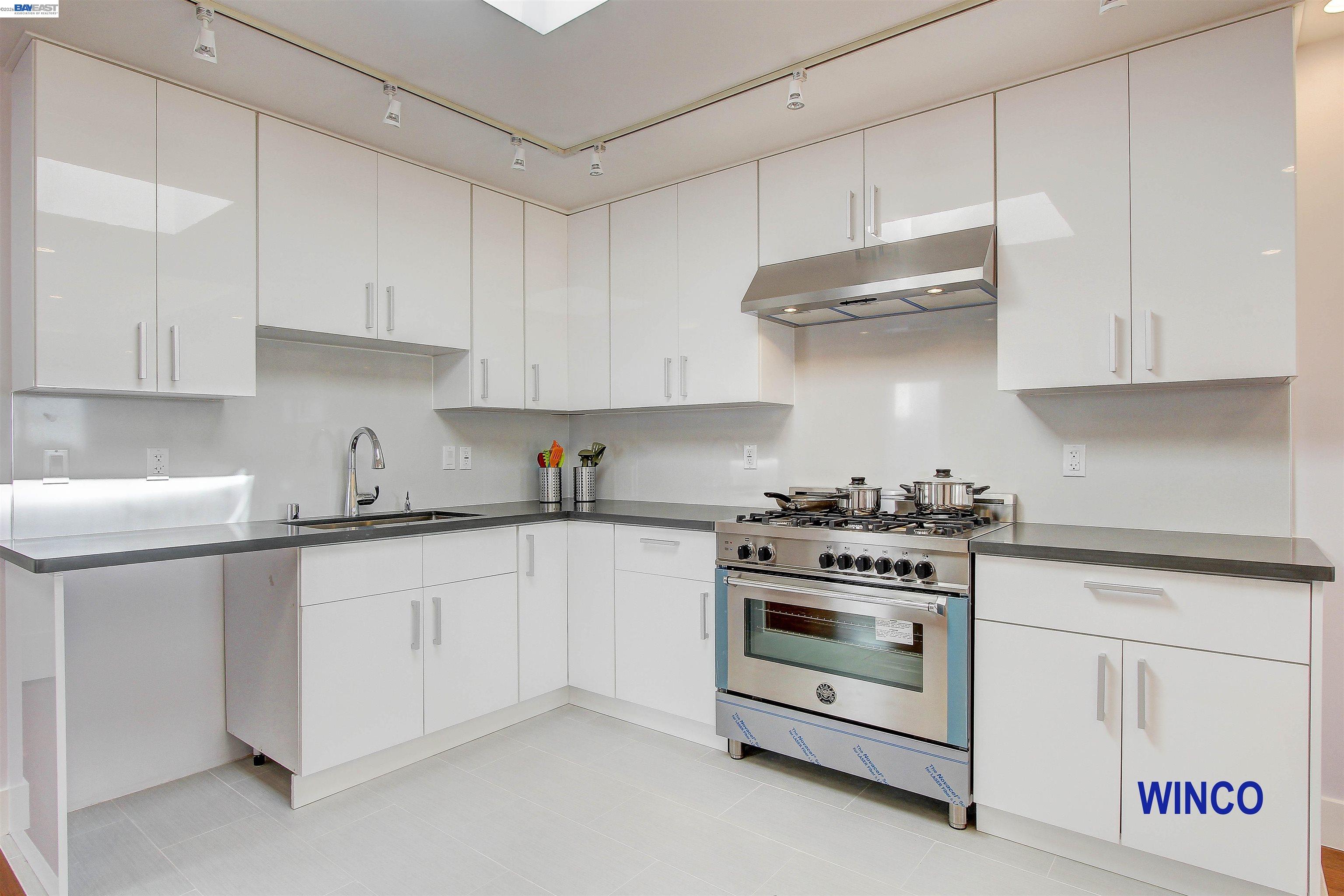 263 Ralston Street San Francisco, CA 94132 - Photo 4 of 28 a kitchen with stainless steel appliances white cabinets and a stove a sink