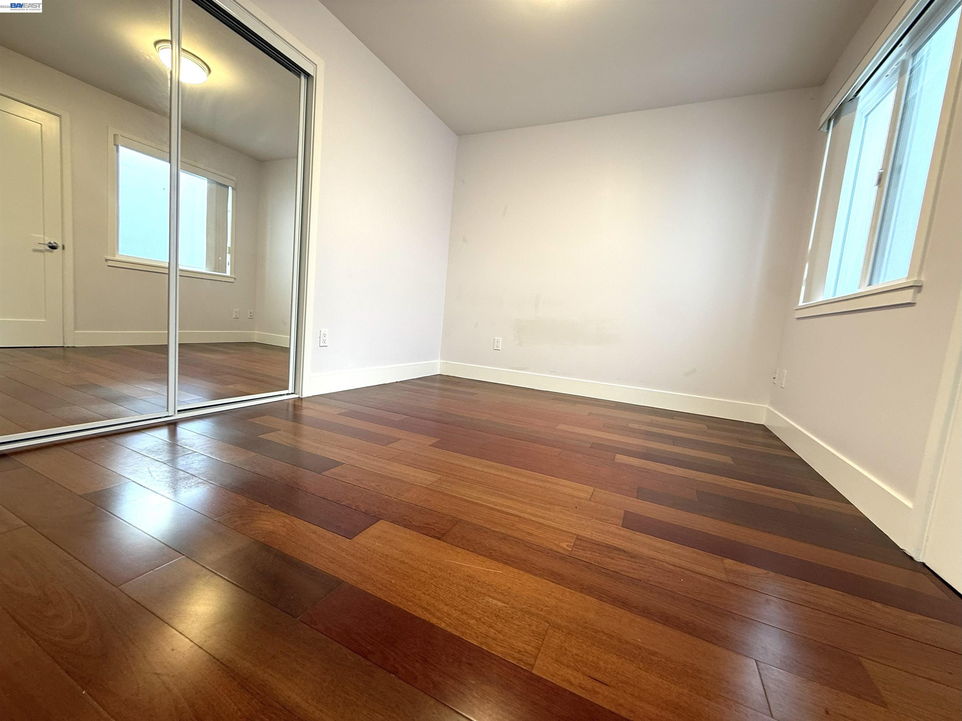263 Ralston Street San Francisco, CA 94132 - Photo 6 of 28 an empty room with wooden floor and windows