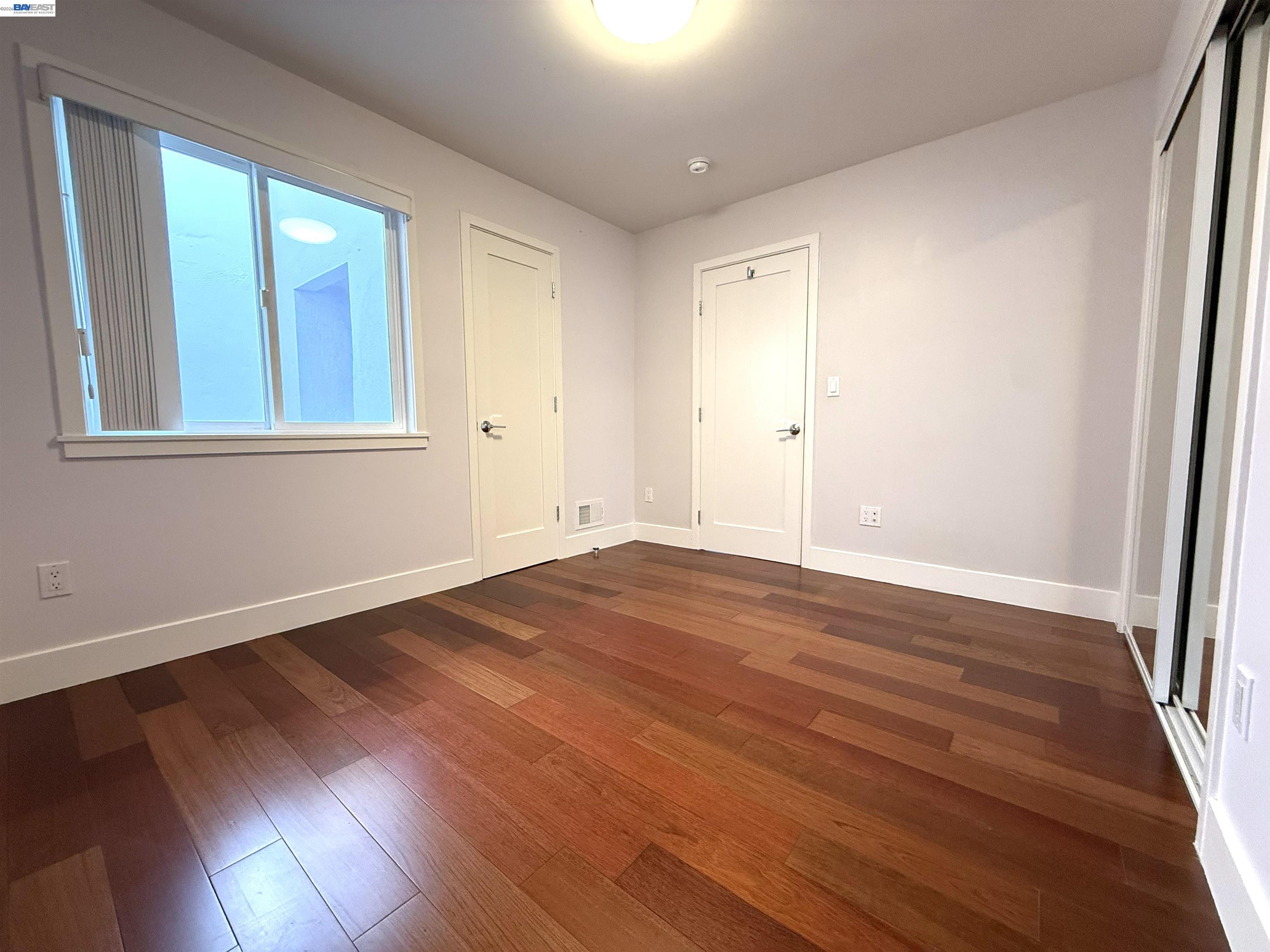 263 Ralston Street San Francisco, CA 94132 - Photo 7 of 28 a view of an empty room with wooden floor and a window