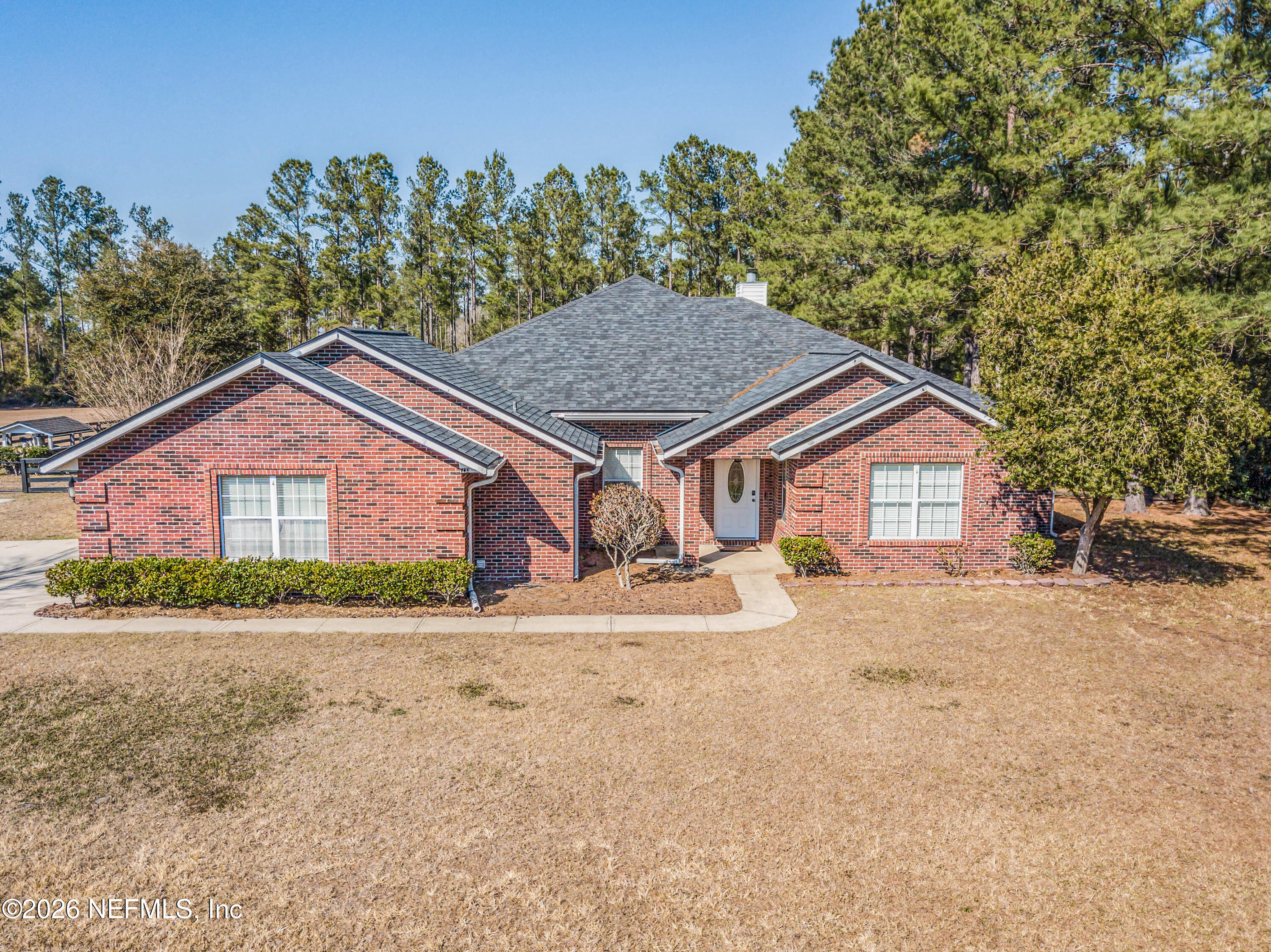 7733 Odis Yarborough Road Glen St. Mary, FL 32040 - Photo 1 of 45 a view of a house with a yard and large trees