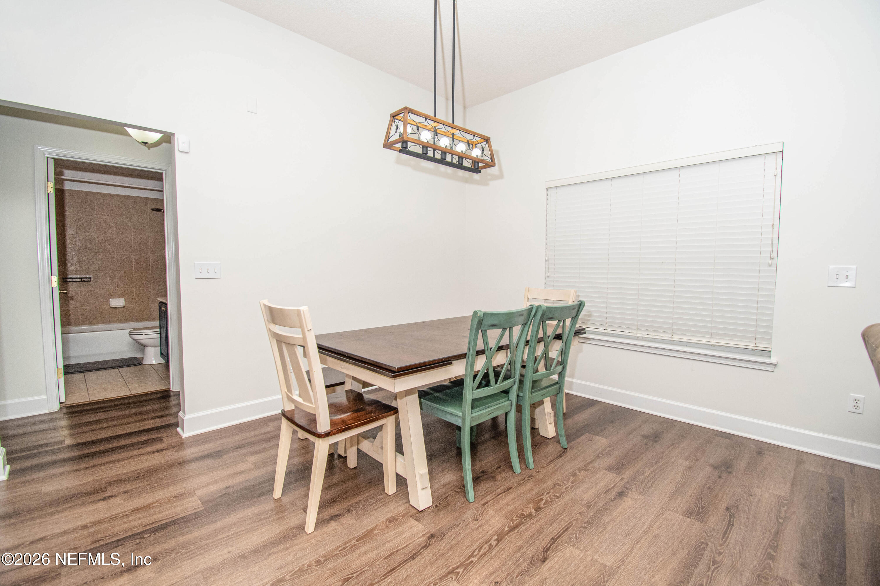 7733 Odis Yarborough Road Glen St. Mary, FL 32040 - Photo 13 of 45 a view of a dining room with furniture and wooden floor