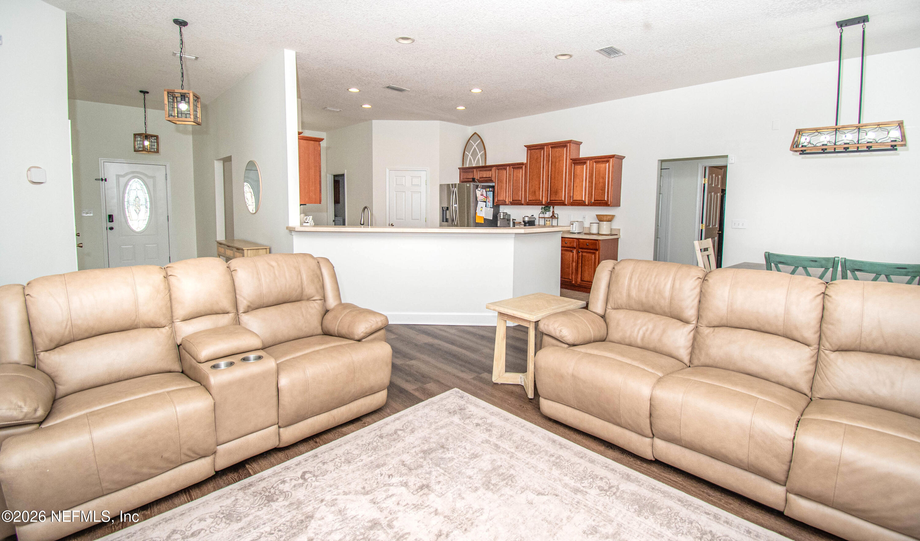 7733 Odis Yarborough Road Glen St. Mary, FL 32040 - Photo 17 of 45 a living room with furniture and kitchen view