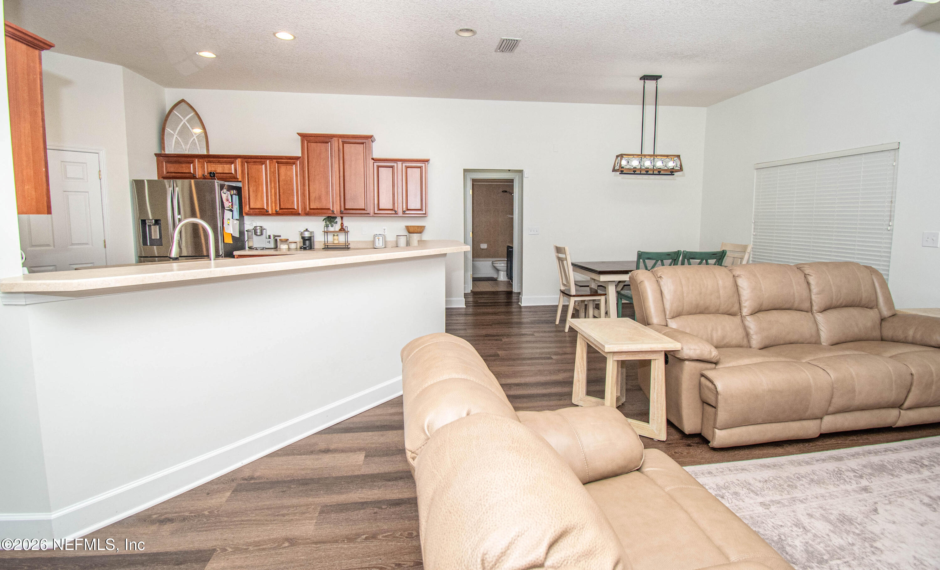 7733 Odis Yarborough Road Glen St. Mary, FL 32040 - Photo 19 of 45 a living room with furniture and wooden floor