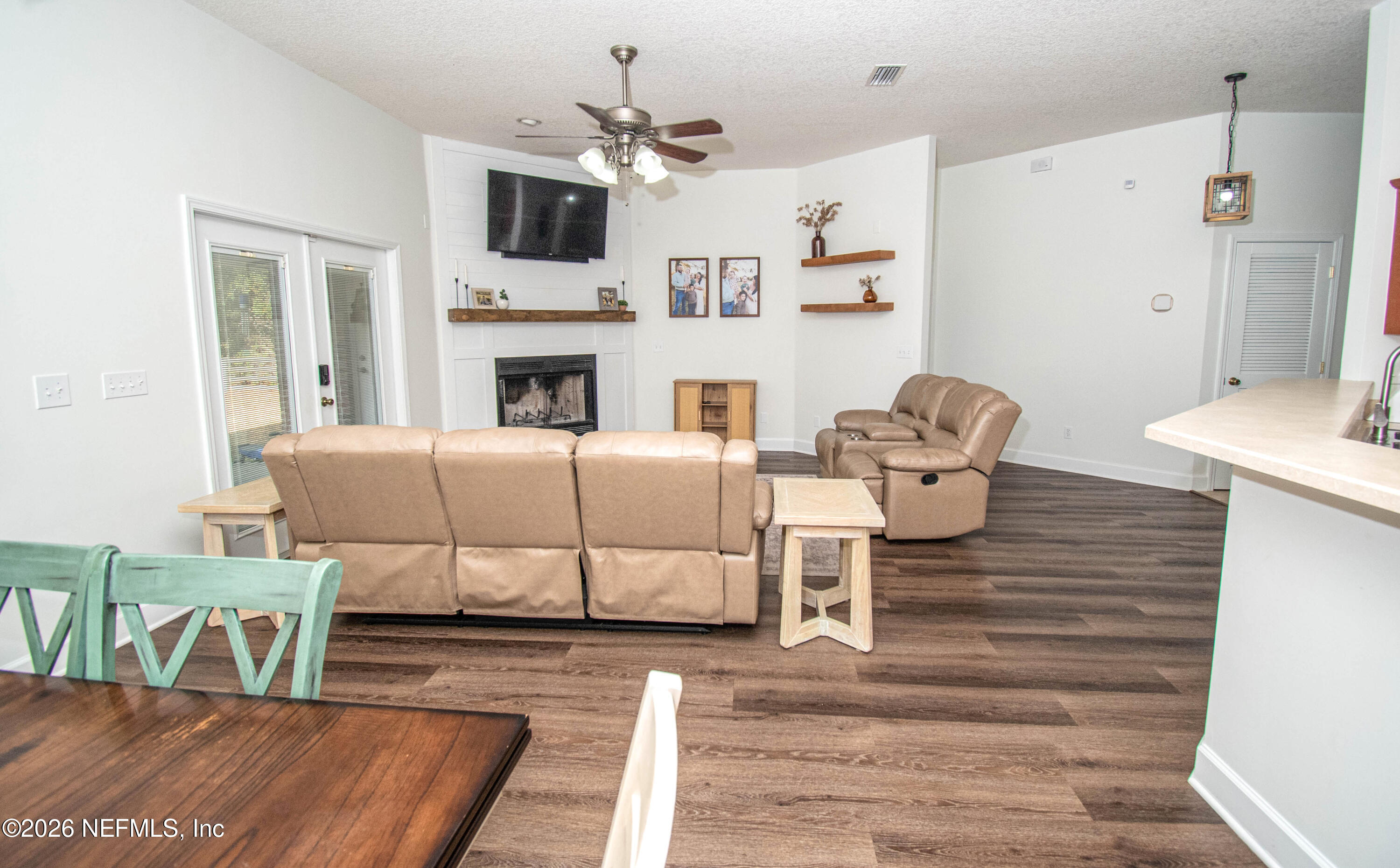 7733 Odis Yarborough Road Glen St. Mary, FL 32040 - Photo 20 of 45 a living room with furniture a flat screen tv and kitchen view
