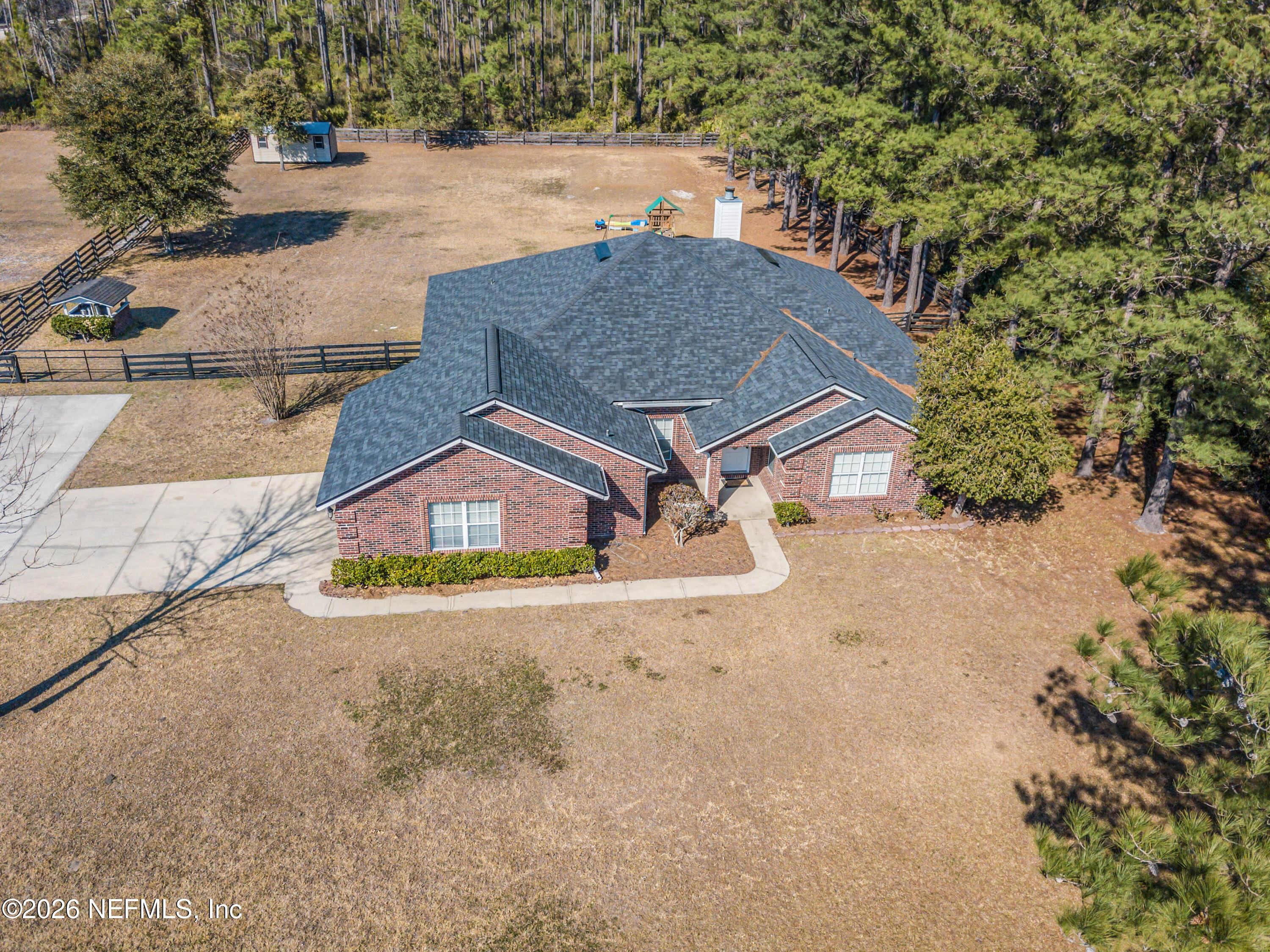7733 Odis Yarborough Road Glen St. Mary, FL 32040 - Photo 2 of 45 an aerial view of a house with a yard and garage
