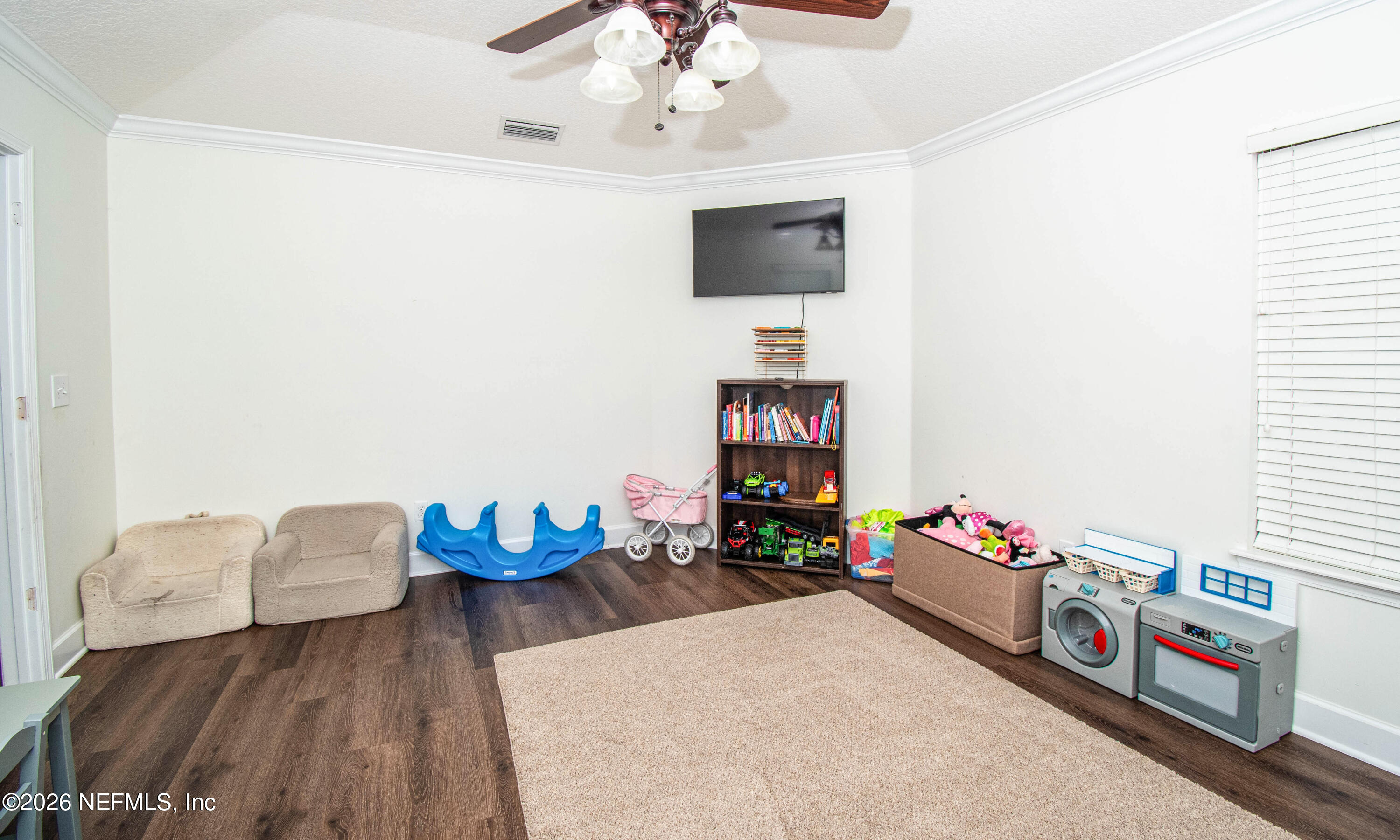 7733 Odis Yarborough Road Glen St. Mary, FL 32040 - Photo 28 of 45 a living room with furniture and a flat screen tv
