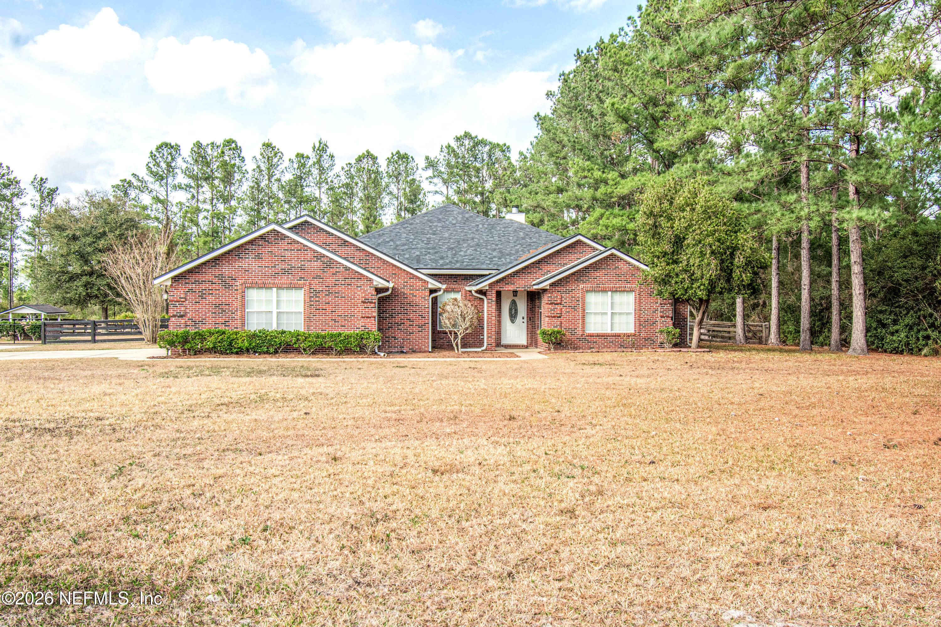 7733 Odis Yarborough Road Glen St. Mary, FL 32040 - Photo 3 of 45 a house with a wooden fence