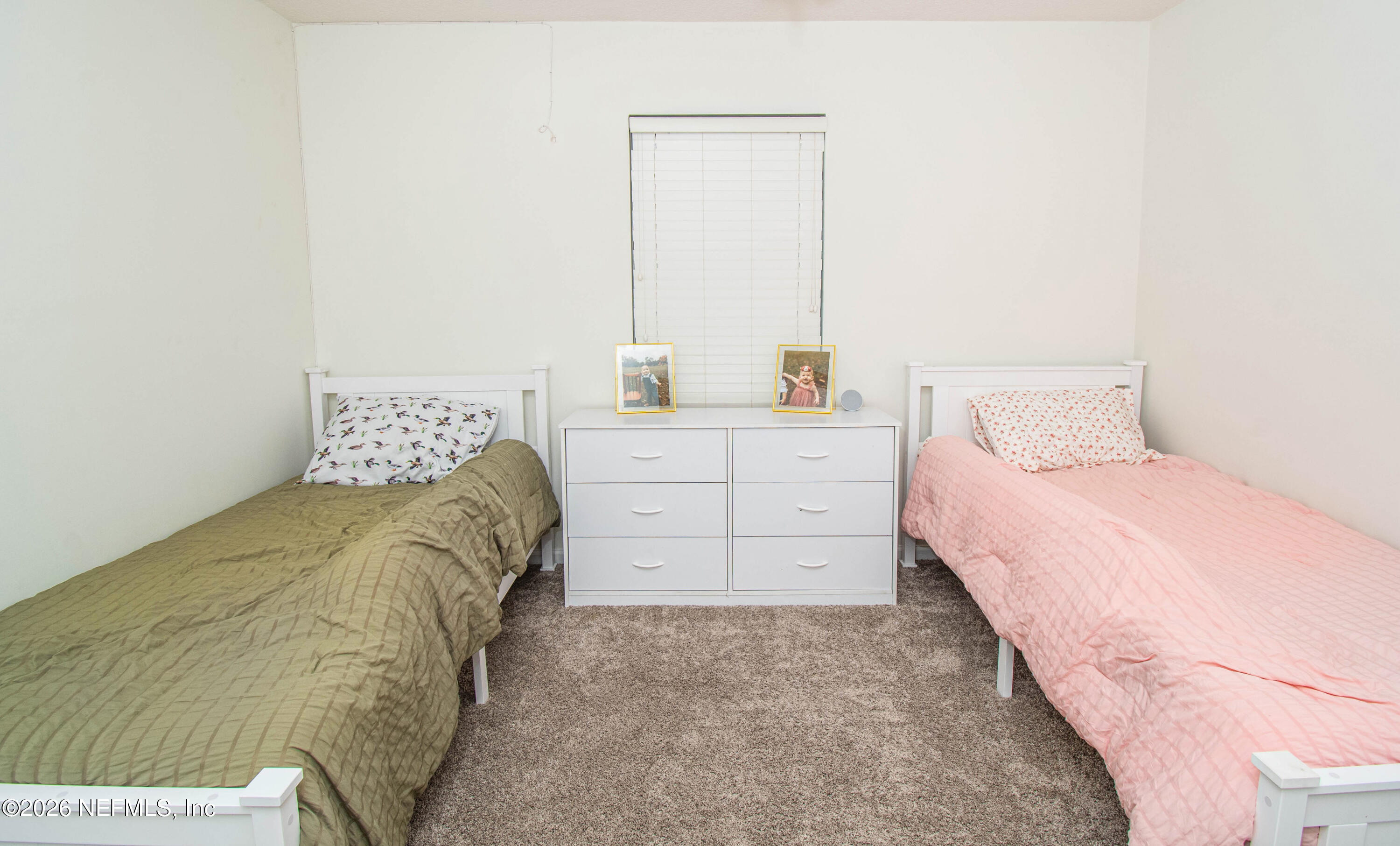7733 Odis Yarborough Road Glen St. Mary, FL 32040 - Photo 31 of 45 a bedroom with a bed and a window