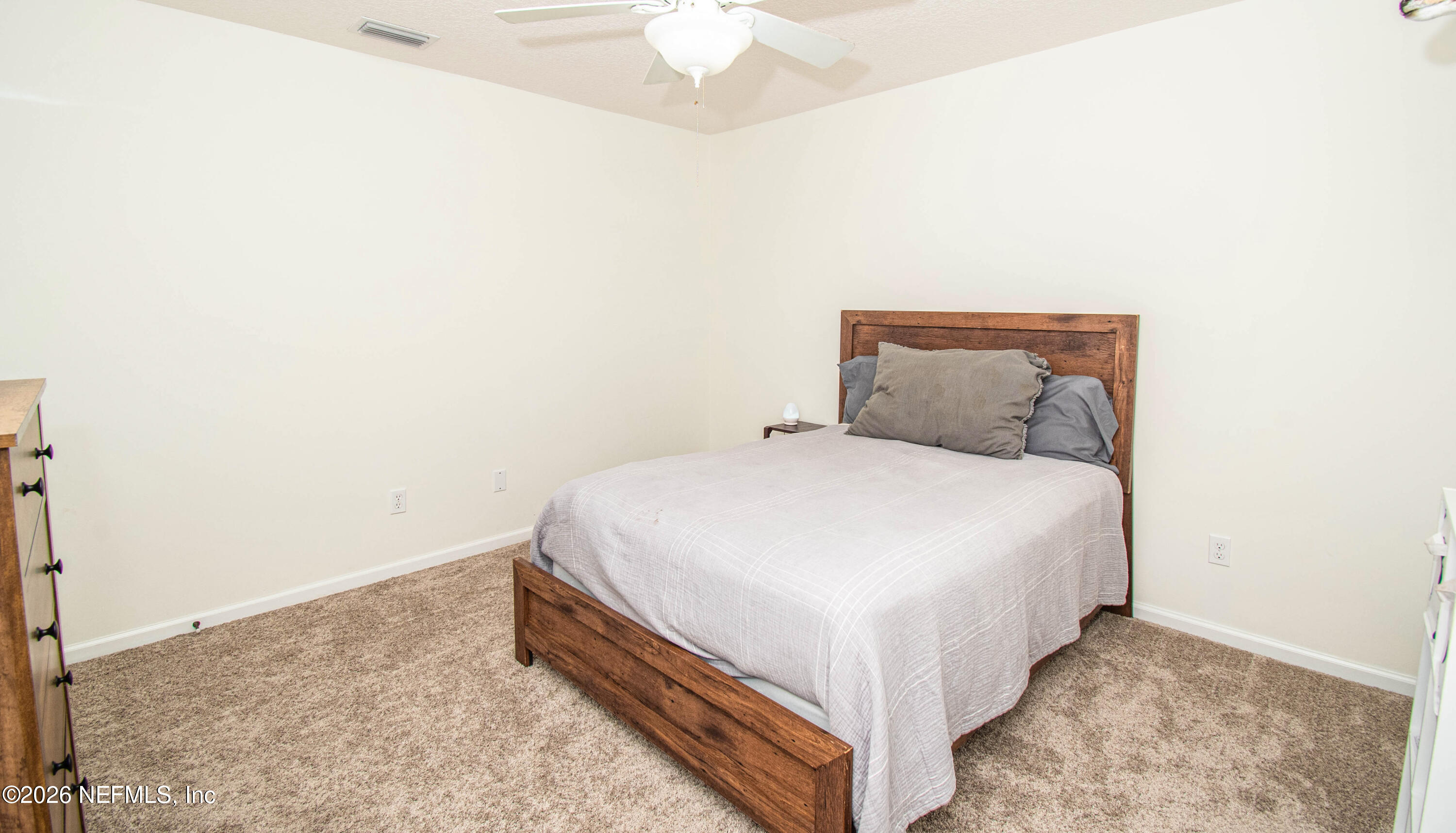 7733 Odis Yarborough Road Glen St. Mary, FL 32040 - Photo 35 of 45 a bed room with a bed and a chandelier