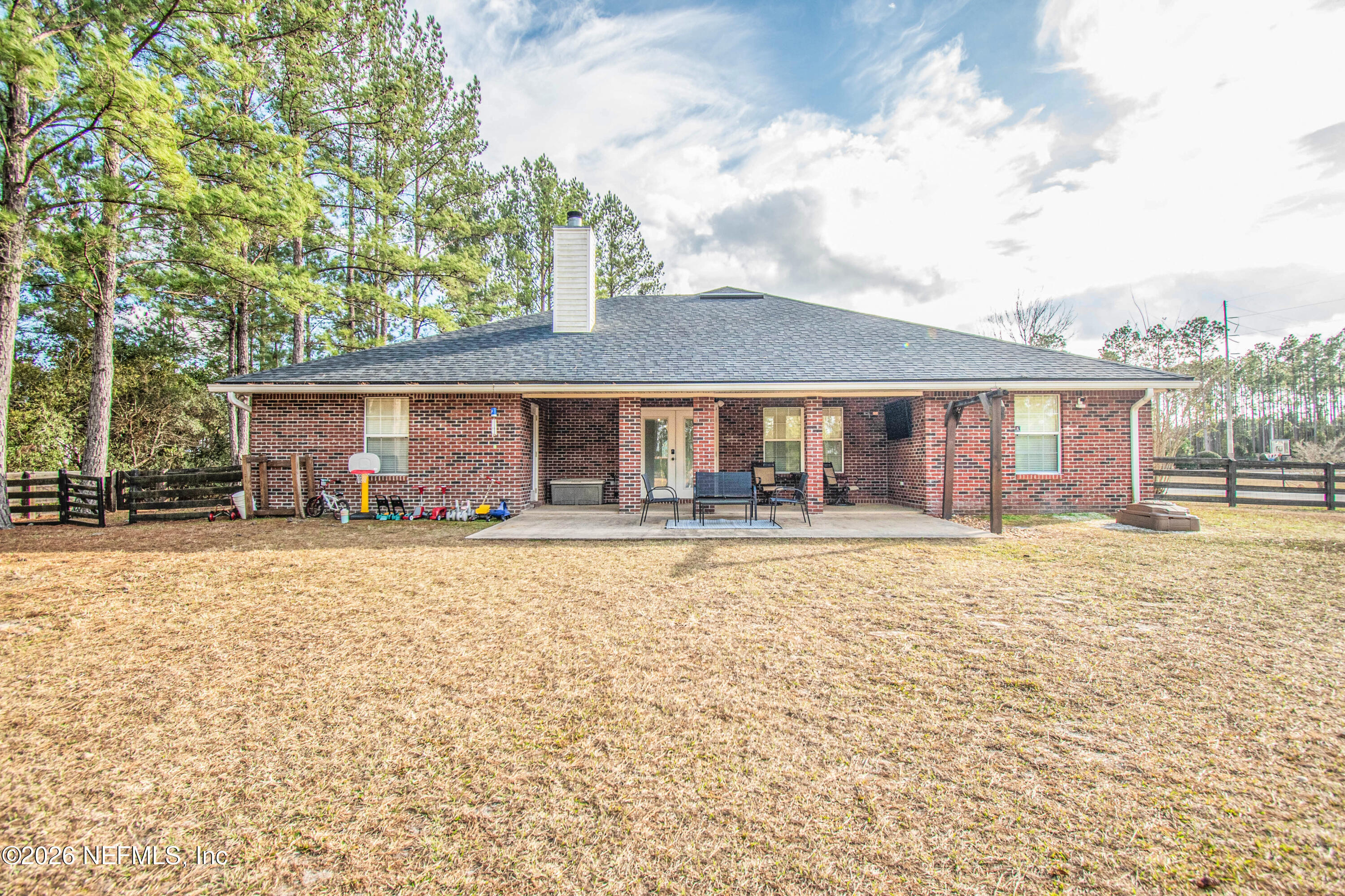 7733 Odis Yarborough Road Glen St. Mary, FL 32040 - Photo 37 of 45 a front view of a house with basket ball court and outdoor seating