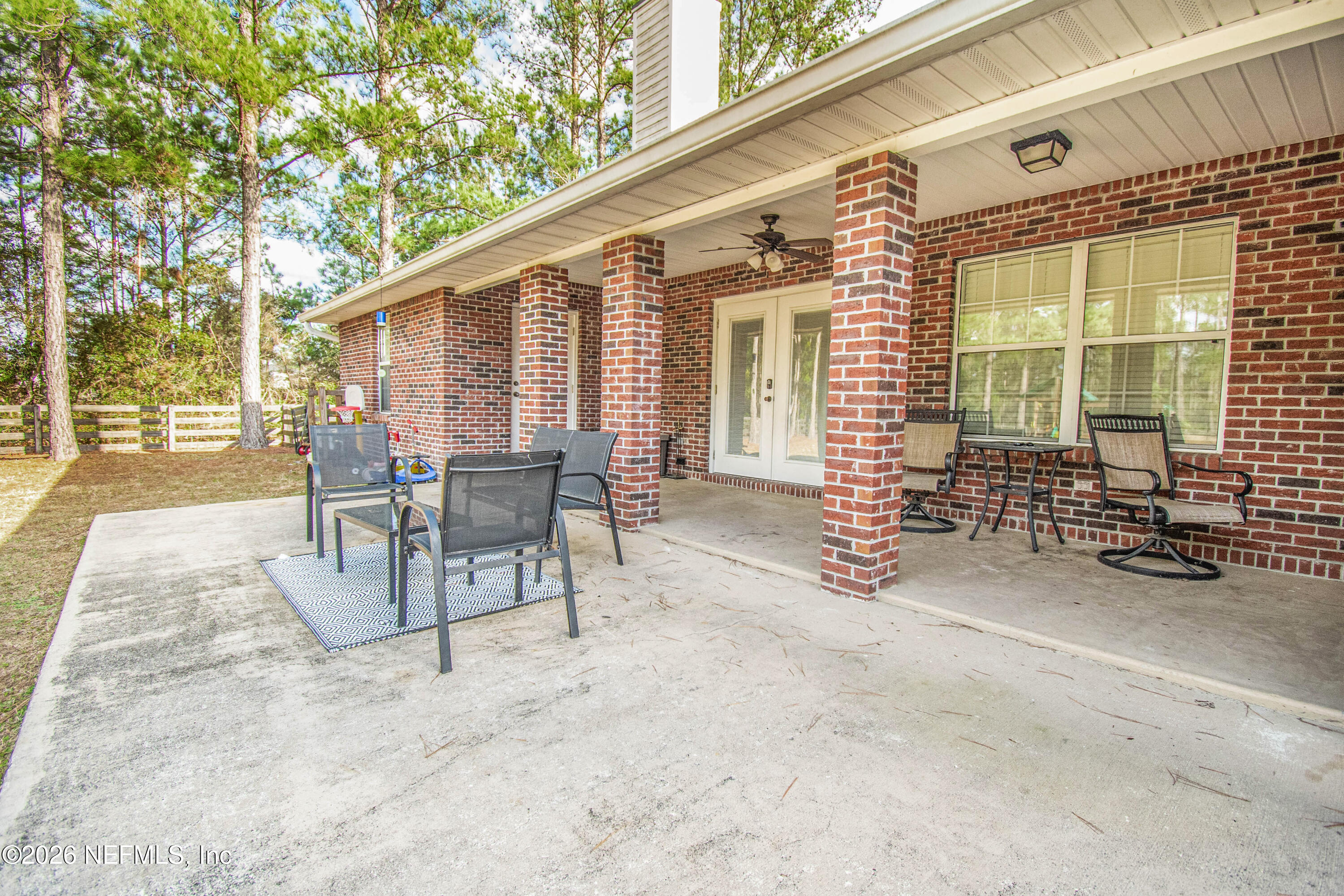 7733 Odis Yarborough Road Glen St. Mary, FL 32040 - Photo 38 of 45 a view of a patio with a table and chairs and couches