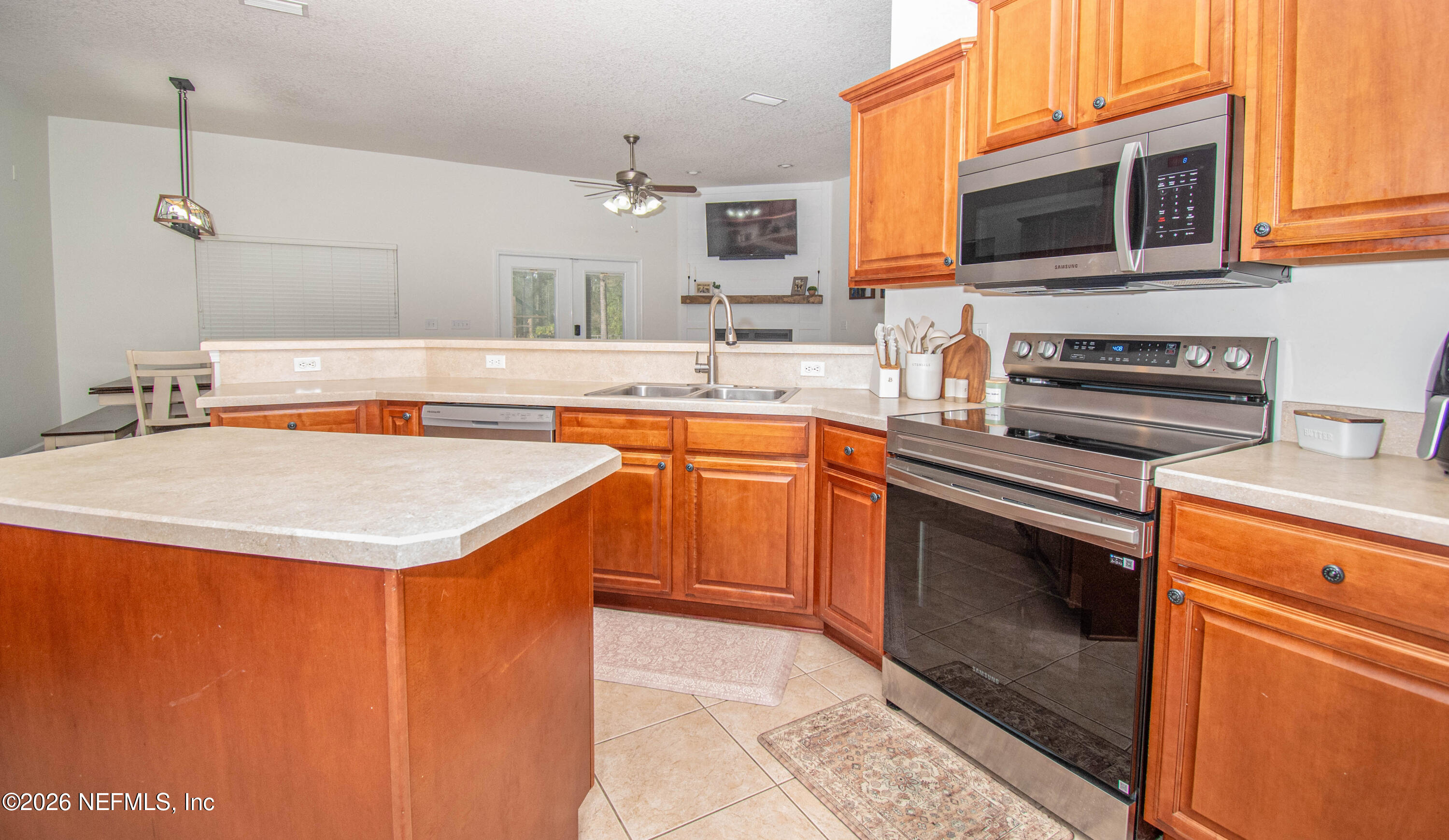 7733 Odis Yarborough Road Glen St. Mary, FL 32040 - Photo 7 of 45 a kitchen with stainless steel appliances granite countertop a sink stove and microwave
