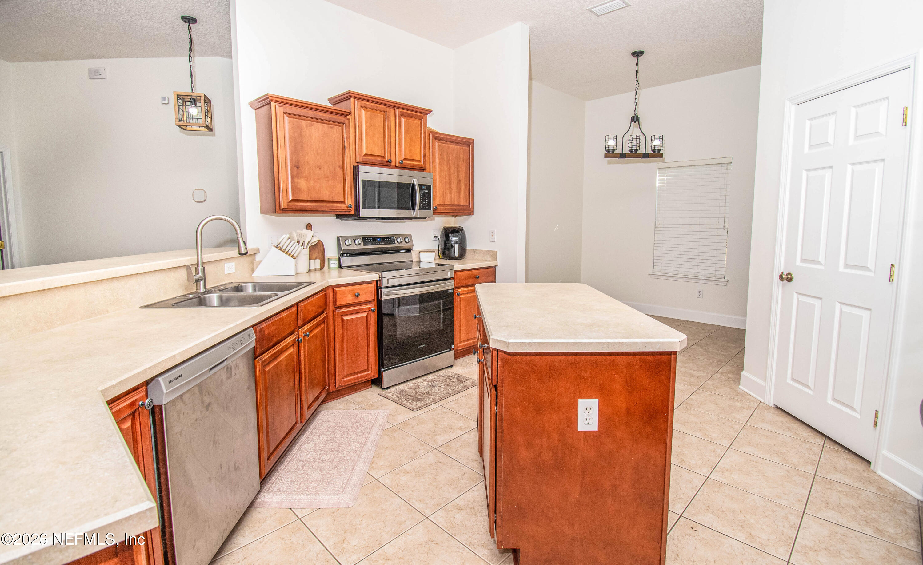 7733 Odis Yarborough Road Glen St. Mary, FL 32040 - Photo 9 of 45 a kitchen with stainless steel appliances granite countertop a sink stove and refrigerator