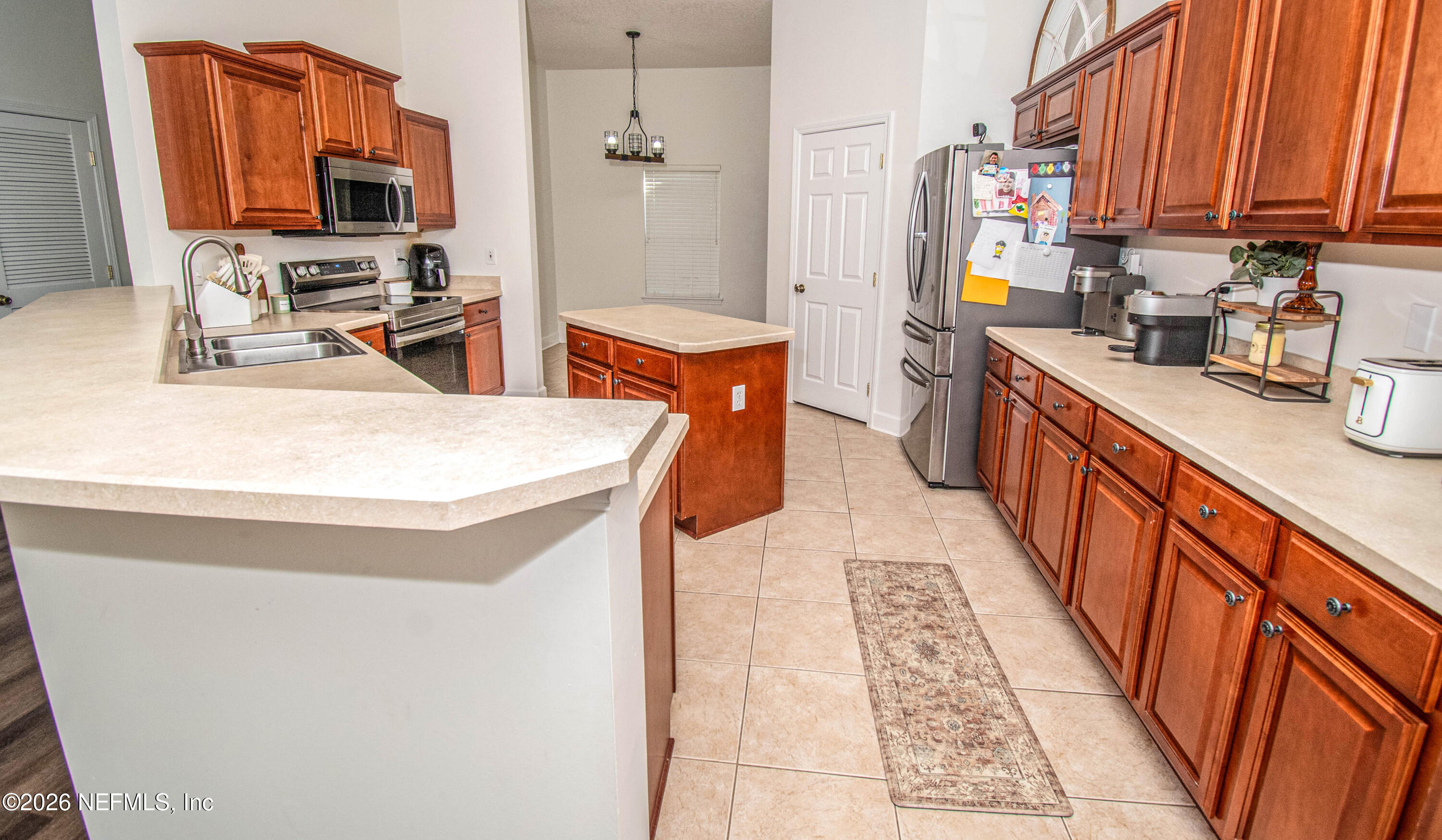 7733 Odis Yarborough Road Glen St. Mary, FL 32040 - Photo 10 of 45 a kitchen with stainless steel appliances a sink a stove top oven a refrigerator and dishwasher