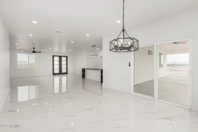 a view of a hallway with chandelier and entryway