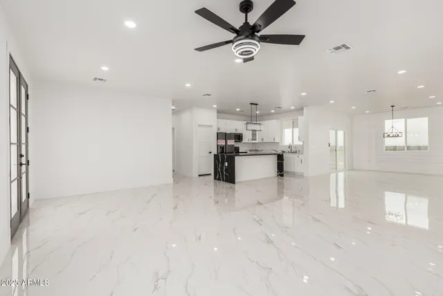 a view of kitchen with kitchen island stainless steel appliances refrigerator stove microwave and cabinets